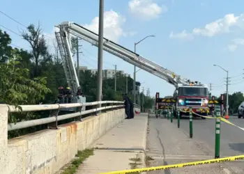 Firefighters used an elevated ladder, deployed over the side of the Adelaide Street bridge in London to search for the child from above. (Isha Bhargava/ CBC News)