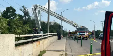 Firefighters used an elevated ladder, deployed over the side of the Adelaide Street bridge in London to search for the child from above. (Isha Bhargava/ CBC News)