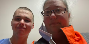 Logan Tozer, left, and his mother pose for a photo at the hospital where he was being assessed on Wednesday. Logan, who has autism, was missing for more than two weeks before police found him in an abandoned building in Havelock, Ont.