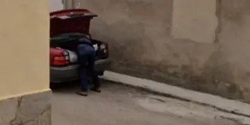 A picture, which Spanish police used as part of a missing person investigation, shows a man placing what appears to be a bag with a body in a car's trunk, in Tajueco, Spain, dated October 2024 (Courtesy Google Street View/Handout via REUTERS)