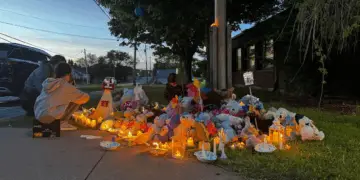 About 50 community members gathered outside the RCMP detachment in Stellarton, N.S., on Monday evening for a candlelight vigil, one month after siblings Lilly and Jack Sullivan were reported missing. (Angela MacIvor/CBC - image credit)