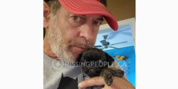 Photo of missing man Shawn Roy, age 60, from Ottawa, Ontario, wearing a red cap and holding a small dog