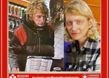 Photo of missing man Noel, age 28, shoulder-length blonde hair, wearing black winter jacket with red patches, from North Bay, Ontario.