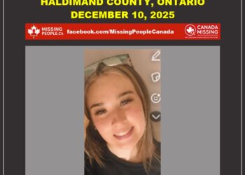 Photo of missing female teen Autumn Steele-Cluckie, age 17, from Haldimand County, Ontario (young woman with long brown hair, smiling, wearing glasses, black top).